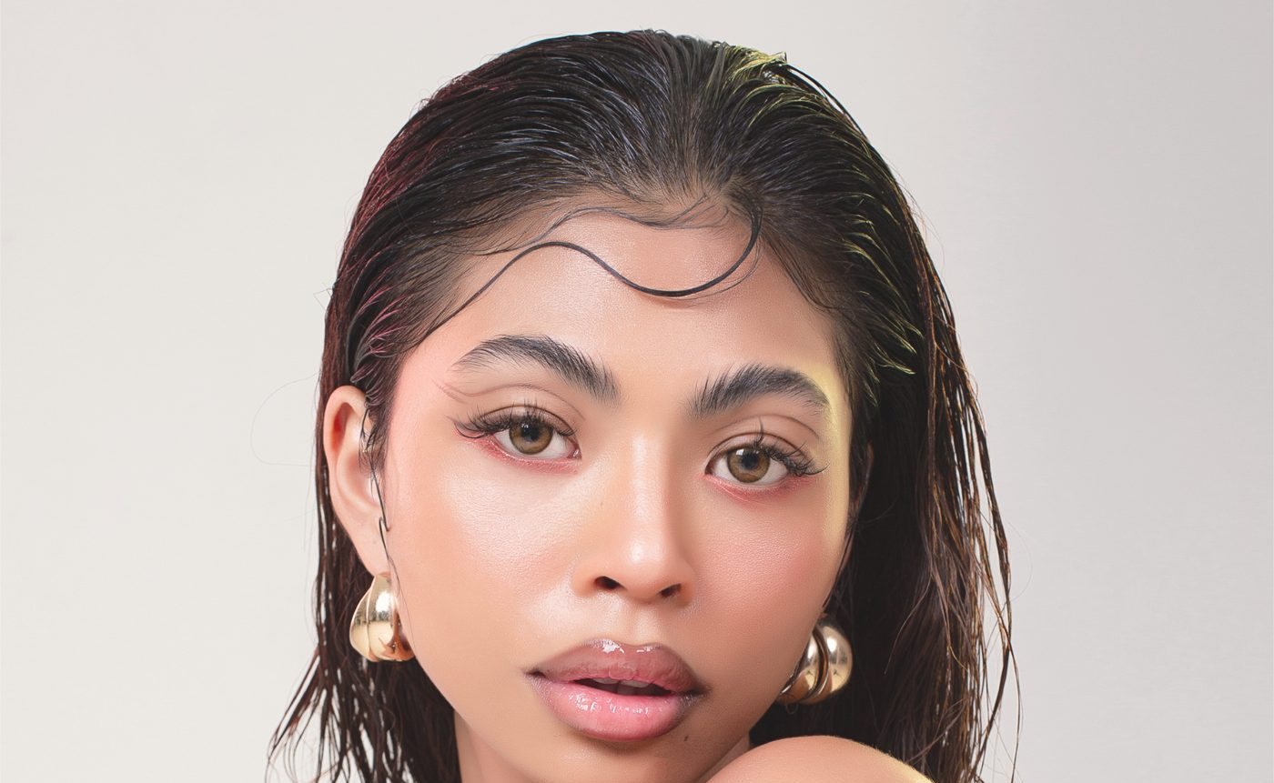 Portrait with a soft peach glow, wearing Hello Peachy makeup